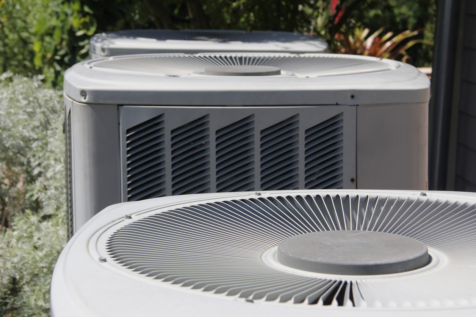 air-conditioner-units-near-green-foliage-on-a-sunn-2026-03-17-00-44-06-utc